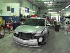 Silver sedan with visible front-end collision damage