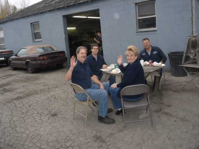The Northline crew eating lunch outside while a coworker photobombs them
